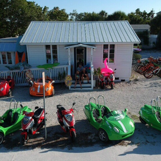 a green motorcycle parked on the side of a road